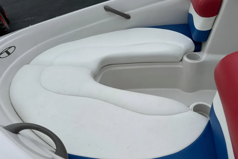 Slide: The Image of 2007 Tahoe Q4 Sport boat interior with white and blue cushioned seating. - 3