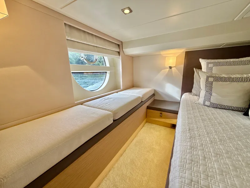 Slide: The Image of Luxurious cabin interior of 2017 Beneteau Monte Carlo 5S yacht, featuring elegant bedding and seating. - 13