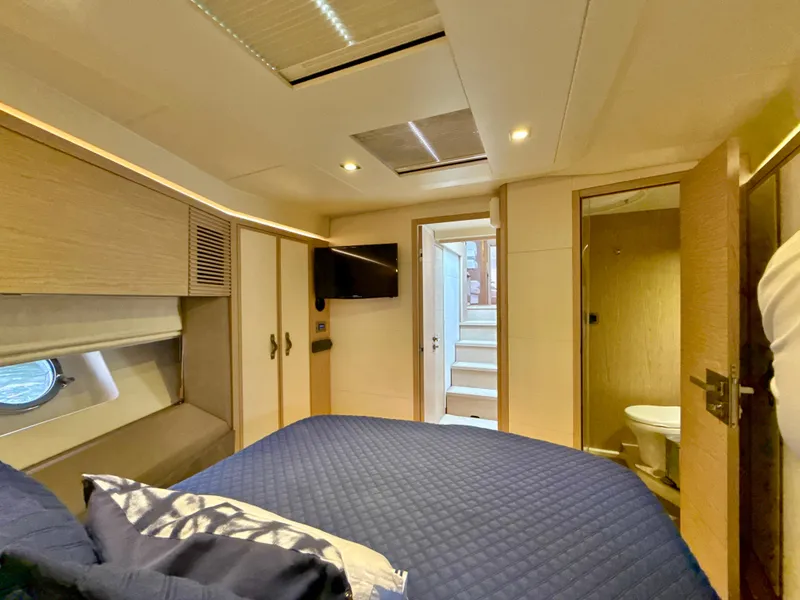 Slide: The Image of Luxurious cabin interior of 2017 Beneteau Monte Carlo 5S yacht, featuring a cozy bed and modern amenities. - 17