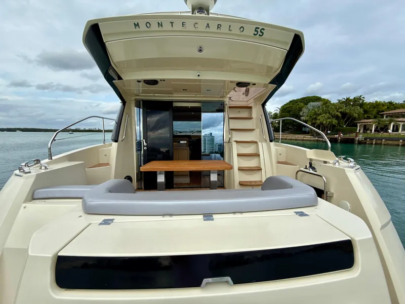 Slide: The Image of 2017 Beneteau Monte Carlo 5S yacht, rear view, docked with open deck and seating area. - 23