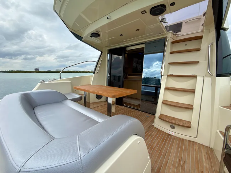 Slide: The Image of 2017 Beneteau Monte Carlo 5S yacht, featuring a sleek deck with seating and table. - 25