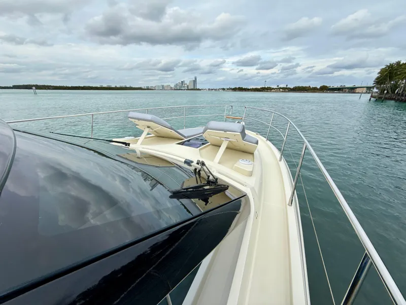 Slide: The Image of 2017 Beneteau Monte Carlo 5S yacht on calm waters, featuring sleek design and sun loungers. - 29