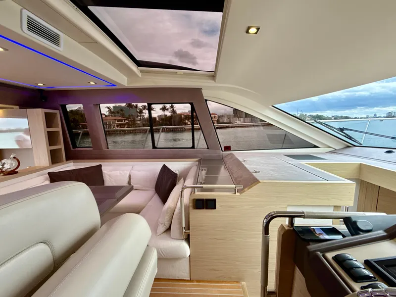 Slide: The Image of Interior of 2017 Beneteau Monte Carlo 5S yacht with modern seating and panoramic windows. - 3