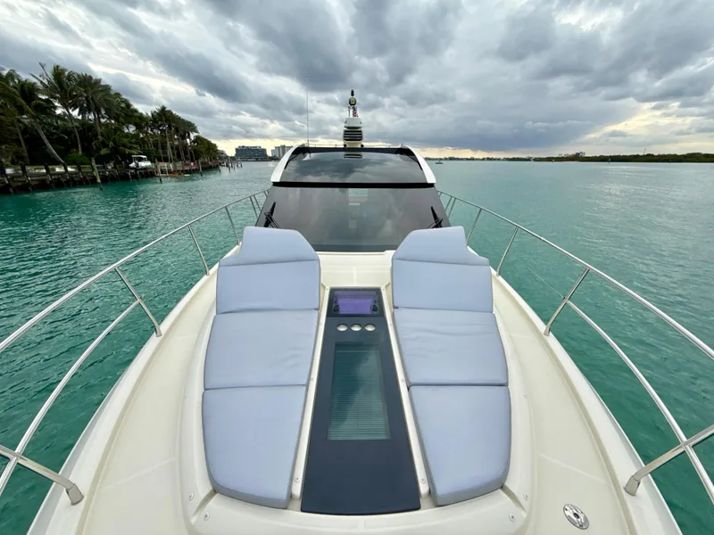 Slide: The Image of 2017 Beneteau Monte Carlo 5S yacht with sun loungers on turquoise water under cloudy sky. - 32