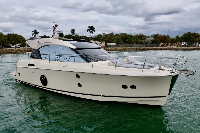 Slide: The Image of 2017 Beneteau Monte Carlo 5S yacht on calm water, cloudy sky backdrop. - 38