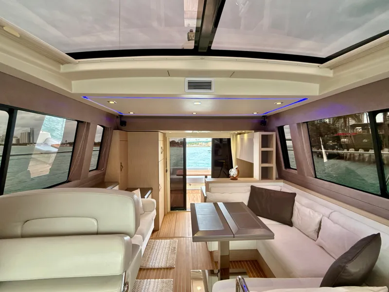 Slide: The Image of Luxurious interior of 2017 Beneteau Monte Carlo 5S yacht with panoramic windows and elegant seating. - 6