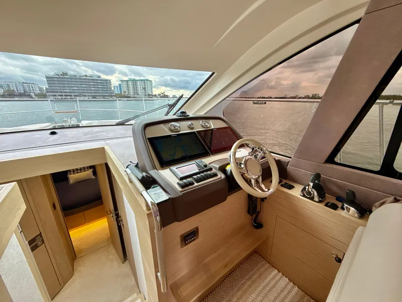 Slide: The Image of 2017 Beneteau Monte Carlo 5S yacht helm with modern controls and waterfront view. - 8