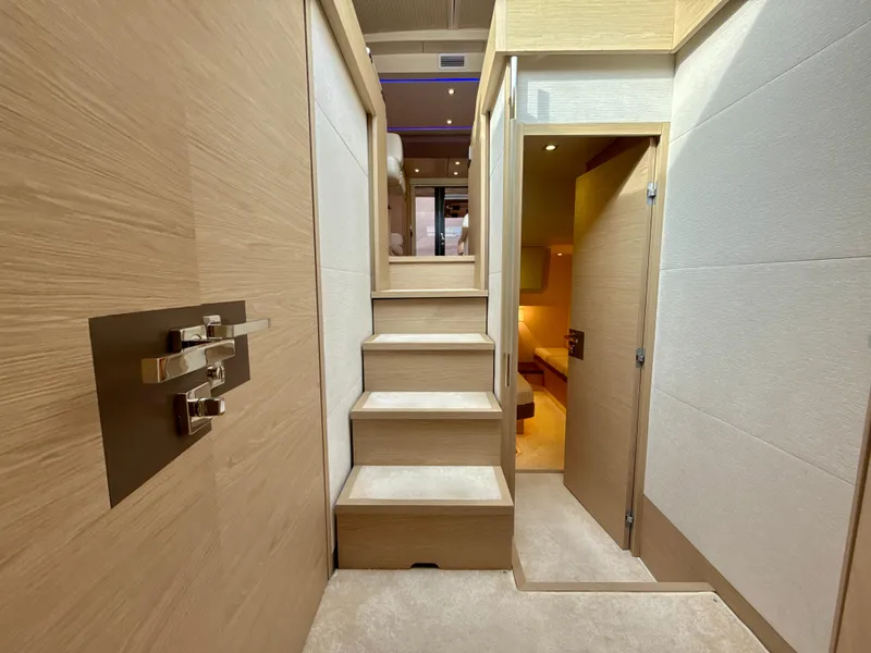 Slide: The Image of Interior of 2017 Beneteau Monte Carlo 5S yacht, featuring modern wooden staircase and elegant design. - 9