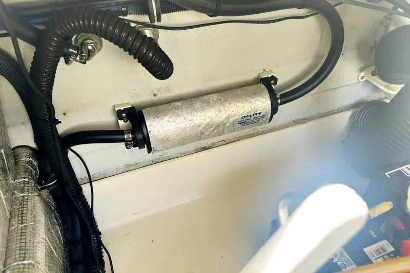 Slide: The Image of Engine compartment of 2013 Chris-Craft Corsair 22 with visible hoses and components. - 10