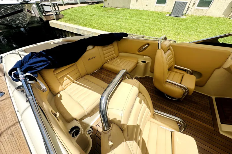 Slide: The Image of 2013 Chris-Craft Corsair 22 boat interior with tan leather seats and wooden flooring. - 17