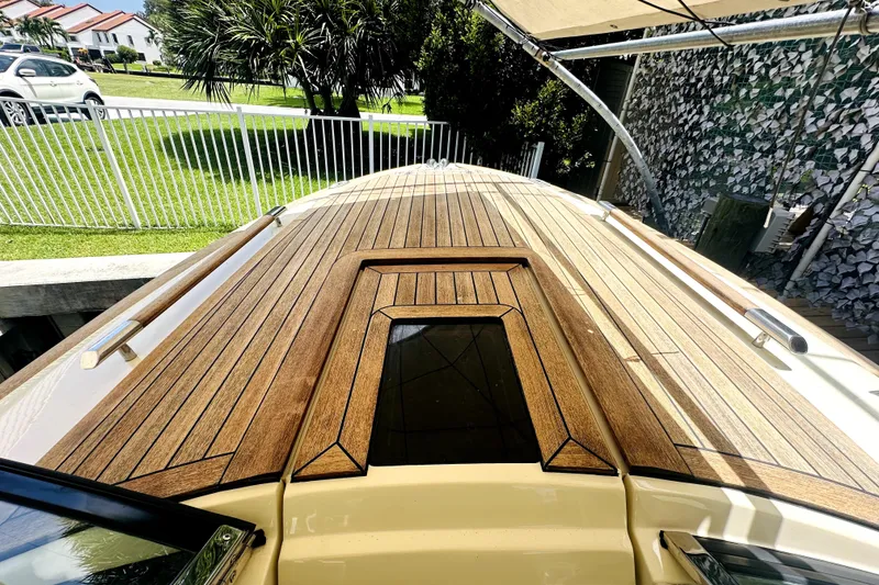 Slide: The Image of 2013 Chris-Craft Corsair 22 boat with sleek wooden deck design. - 2