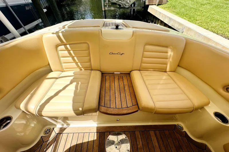 Slide: The Image of Luxurious 2013 Chris-Craft Corsair 22 boat interior with tan leather seats and wooden flooring. - 3