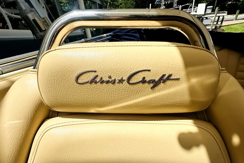 Slide: The Image of 2013 Chris-Craft Corsair 22 boat seat with logo, featuring beige leather upholstery. - 4