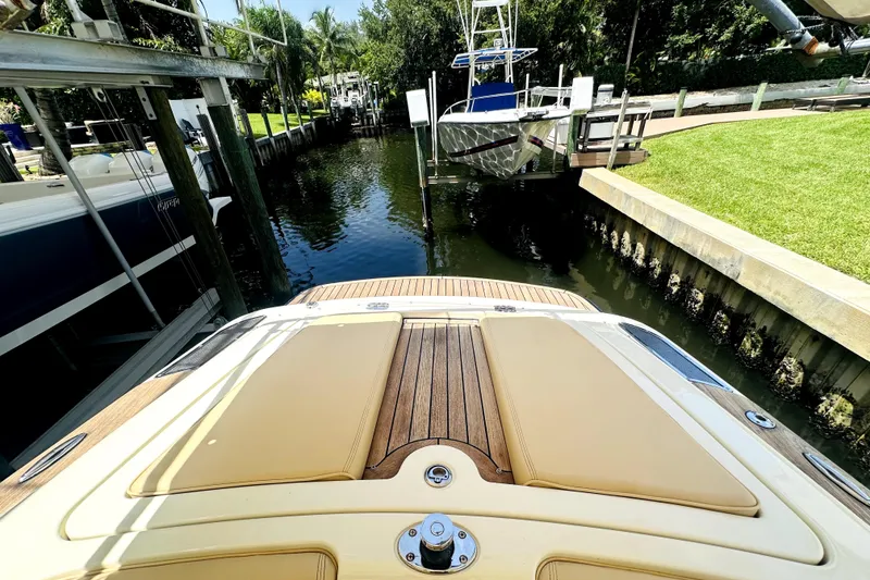 Slide: The Image of 2013 Chris-Craft Corsair 22 docked in a serene canal setting. - 7