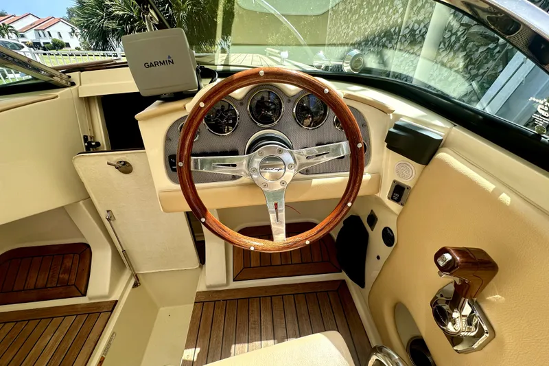 Slide: The Image of Interior of 2013 Chris-Craft Corsair 22 boat with wooden steering wheel and Garmin navigation. - 9
