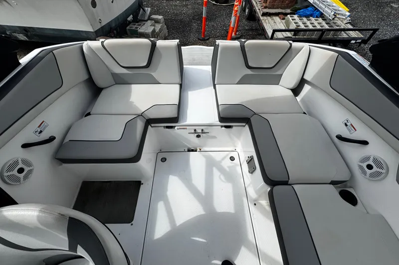 Slide: The Image of 2023 Yamaha Boats AR220 interior seating with gray upholstery and modern design. - 10
