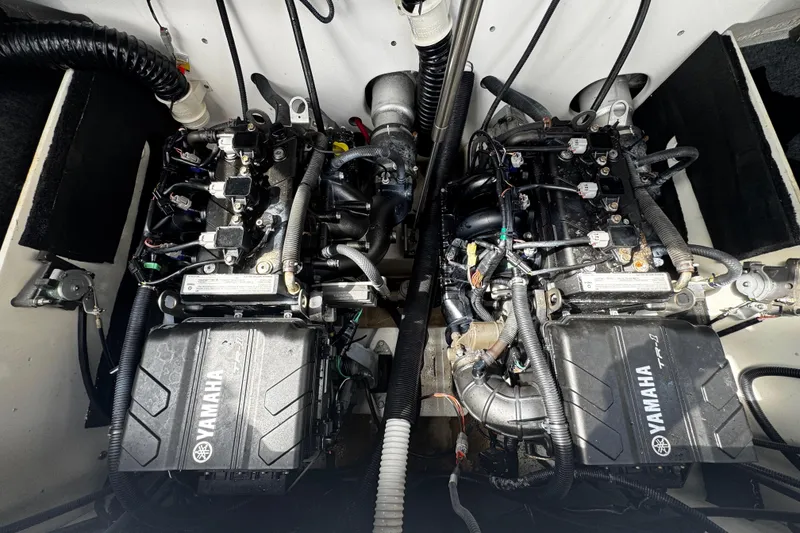 Slide: The Image of 2023 Yamaha AR220 boat engine compartment with dual engines and wiring. - 11