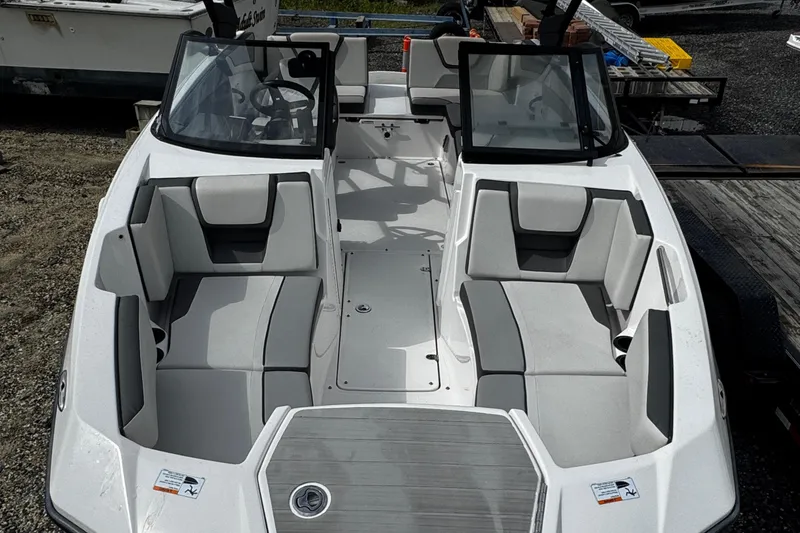 Slide: The Image of 2023 Yamaha Boats AR220 interior with gray seating and open cockpit design. - 6
