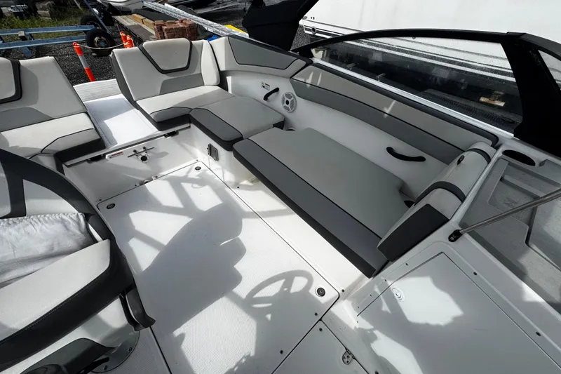 Slide: The Image of 2023 Yamaha Boats AR220 interior with spacious seating and modern design. - 8