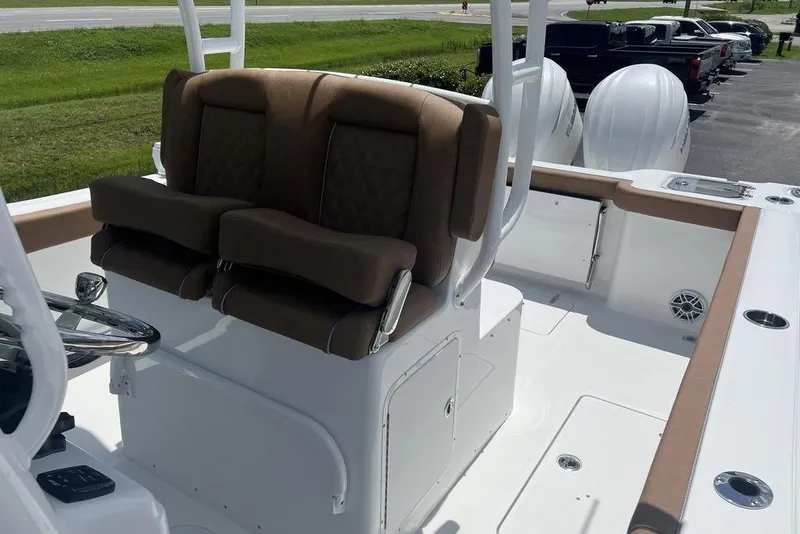 Slide: The Image of 2026 Sea Hunt Gamefish 30 Forward Seating boat interior with cushioned seats and steering console. - 10