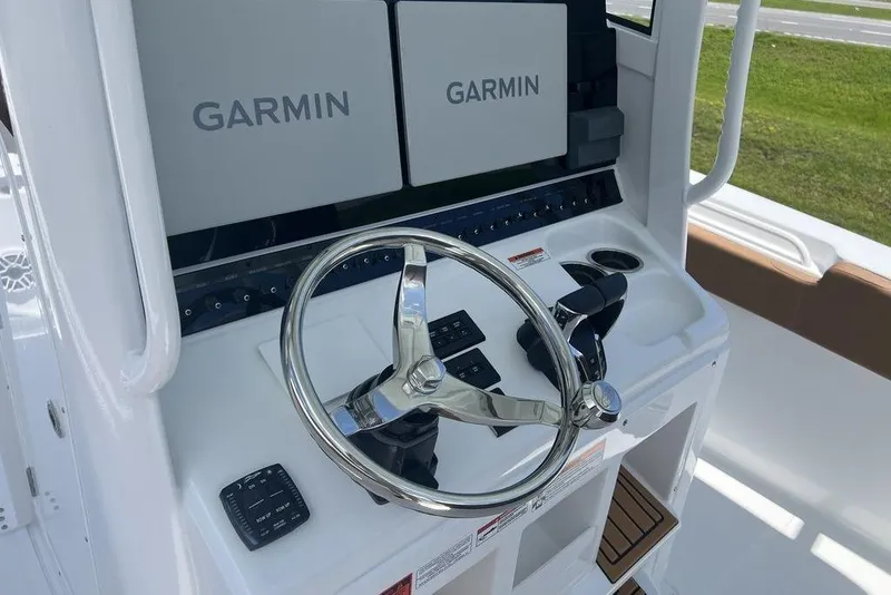 Slide: The Image of 2026 Sea Hunt Gamefish 30 helm with dual Garmin displays and stainless steel steering wheel. - 15