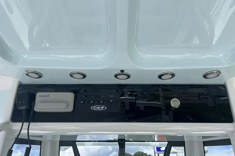 Slide: The Image of 2026 Sea Hunt Gamefish 30 dashboard with Garmin electronics and modern controls. - 23