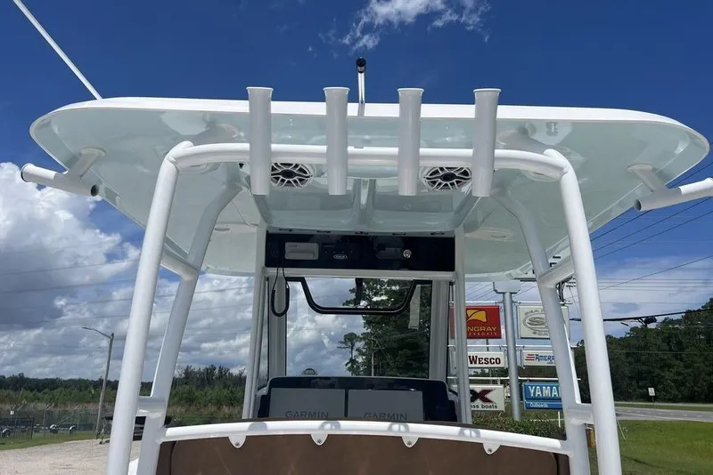 Slide: The Image of 2026 Sea Hunt Gamefish 30 boat with forward seating, featuring a sturdy T-top and rod holders. - 26