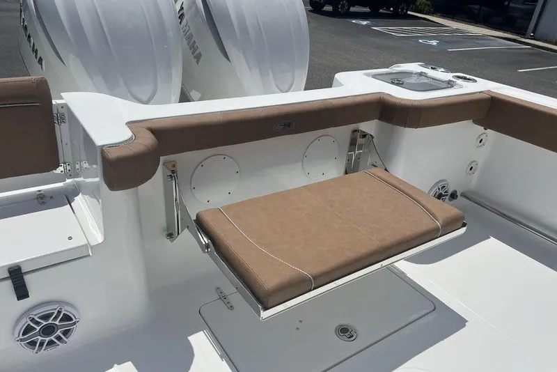 Slide: The Image of 2026 Sea Hunt Gamefish 30 boat with brown cushioned seating and Yamaha engines. - 27