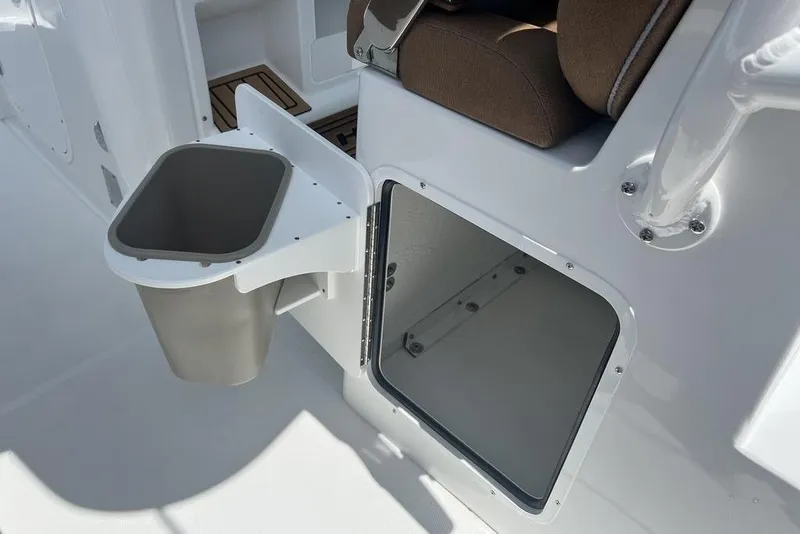 Slide: The Image of 2026 Sea Hunt Gamefish 30 Forward Seating boat interior with storage compartment and trash bin. - 31