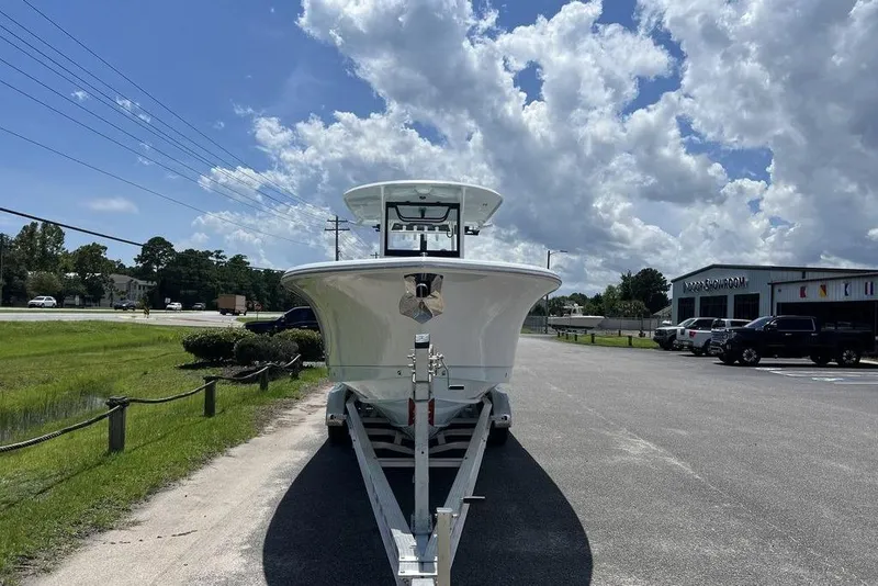 Slide: The Image of 2026 Sea Hunt Gamefish 30 Forward Seating boat on trailer under cloudy sky. - 4