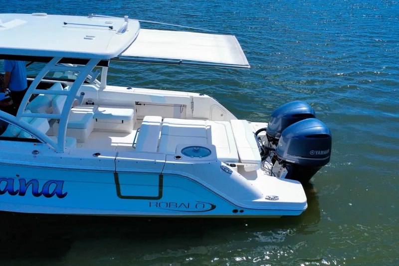 Slide: The Image of 2019 Robalo R317 Dual Console boat with twin Yamaha engines on water. - 10