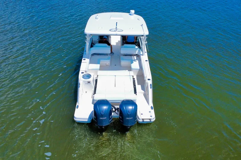 Slide: The Image of 2019 Robalo R317 Dual Console boat with twin engines on clear water. - 11