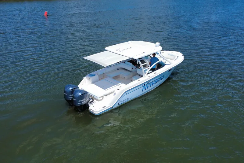 Slide: The Image of 2019 Robalo R317 Dual Console boat on water, featuring twin Yamaha engines. - 12