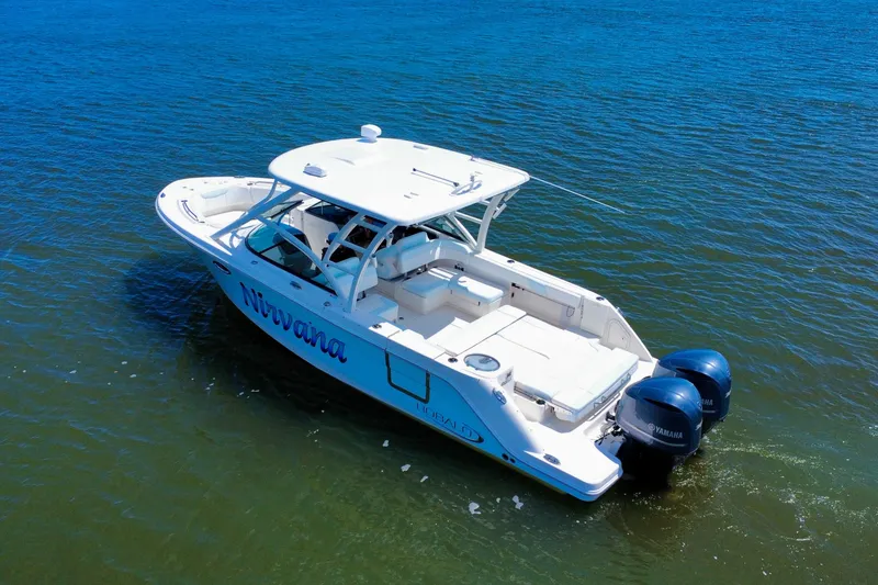 Slide: The Image of 2019 Robalo R317 Dual Console boat on water with twin Yamaha engines. - 13