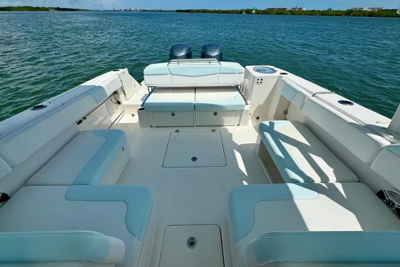 Slide: The Image of 2019 Robalo R317 Dual Console boat interior with spacious seating on calm water. - 19