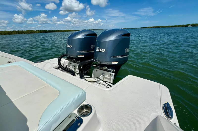 Slide: The Image of 2019 Robalo R317 Dual Console with twin Yamaha 300 engines on open water. - 20
