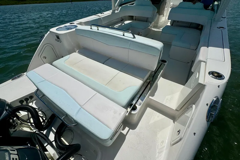 Slide: The Image of 2019 Robalo R317 Dual Console boat interior with seating and water view. - 21