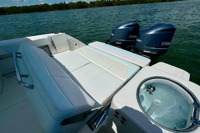 Slide: The Image of 2019 Robalo R317 Dual Console boat with Yamaha engines on a serene lake. - 22