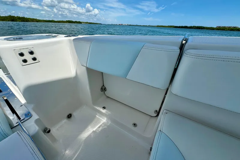 Slide: The Image of 2019 Robalo R317 Dual Console boat interior with seating, ocean view, and clear sky. - 24