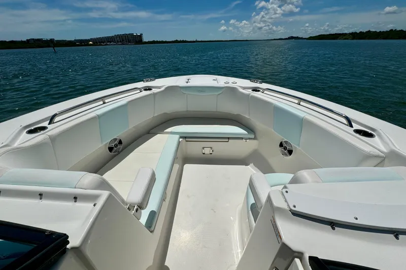 Slide: The Image of 2019 Robalo R317 Dual Console boat interior with spacious seating on calm water. - 26
