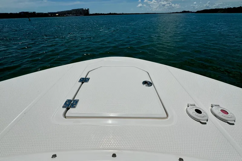 Slide: The Image of 2019 Robalo R317 Dual Console boat deck on calm water, sunny day. - 27