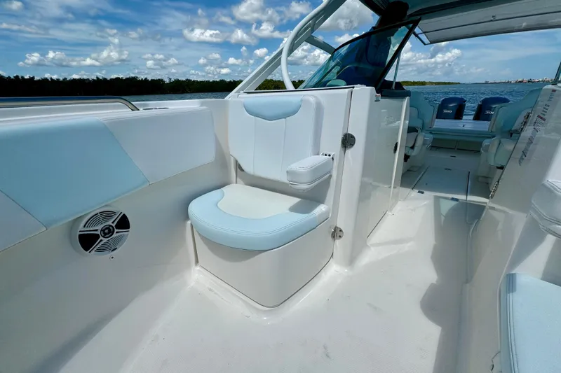 Slide: The Image of 2019 Robalo R317 Dual Console boat interior with seating and ocean view. - 29