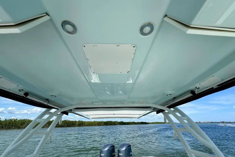 Slide: The Image of 2019 Robalo R317 Dual Console boat canopy view over water. - 31