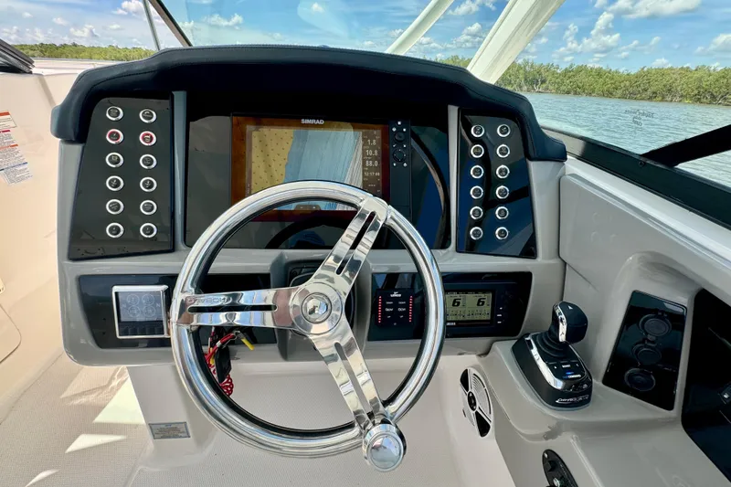 Slide: The Image of 2019 Robalo R317 Dual Console helm with steering wheel and control panel. - 36