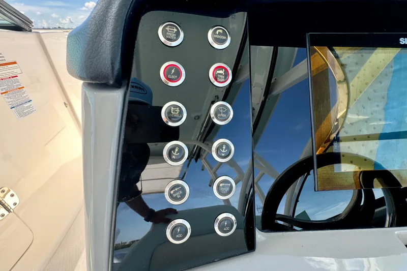 Slide: The Image of Control panel of 2019 Robalo R317 Dual Console boat with various function buttons. - 38