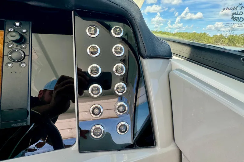 Slide: The Image of Control panel of 2019 Robalo R317 Dual Console boat with various buttons and switches. - 39