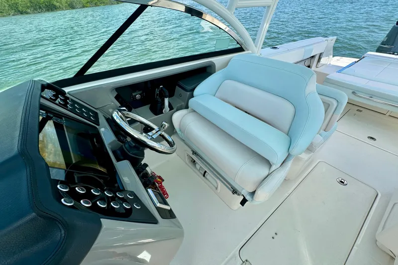 Slide: The Image of 2019 Robalo R317 Dual Console boat interior with steering wheel and seating. - 40