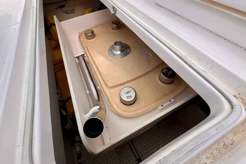Slide: The Image of Storage compartment in 2019 Robalo R317 Dual Console boat, featuring a table and accessories. - 42