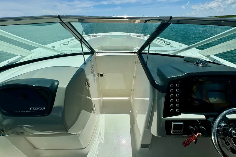 Slide: The Image of 2019 Robalo R317 Dual Console boat interior with steering wheel and dashboard. - 48