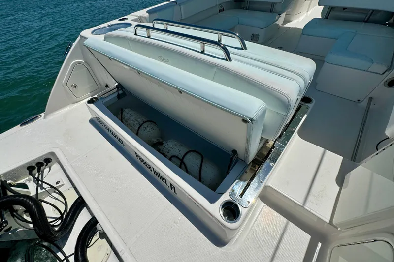 Slide: The Image of 2019 Robalo R317 Dual Console boat with open storage compartment on deck. - 49